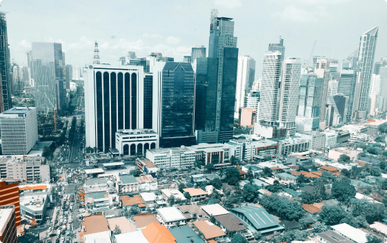 Urban skyline filled with high-rise buildings and a sea of cars on the streets, image